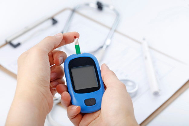 Person using blood glucose meter