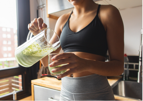 Woman drinking a green smoothie