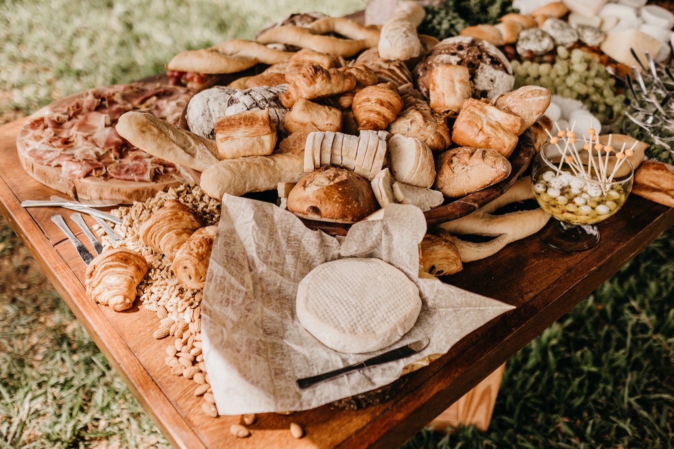 bread, croissants, cheese and ham on a wooden table