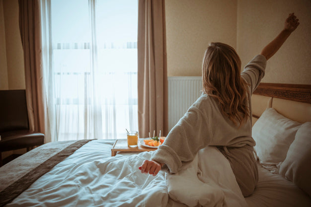 Woman waking up and stretching