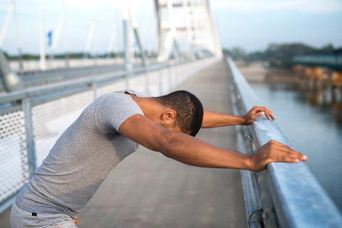 Fit man stretching outdoors.