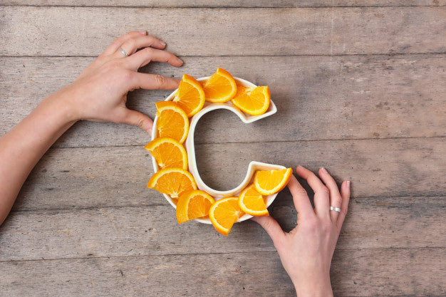 Sliced oranges arranged in a C shape.