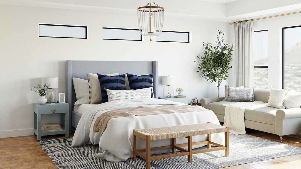 a white bedroom with a blue headboard and a couch