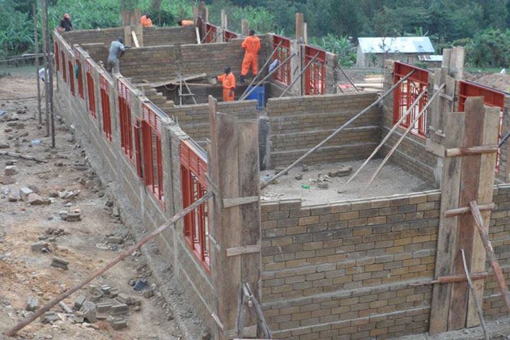 Workers donate time to build school in Uganda