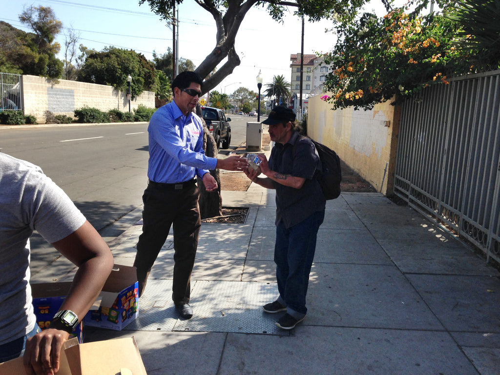 Man hands out water to workers