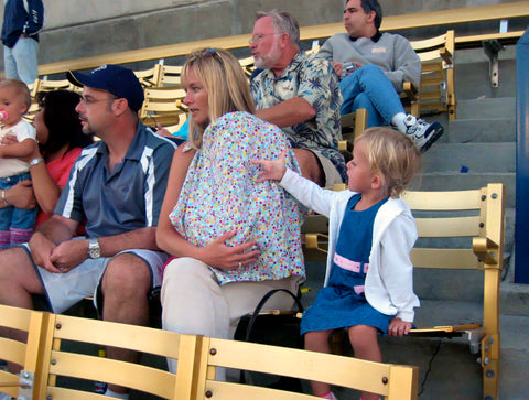 mom using a nursing cover at a soccer game