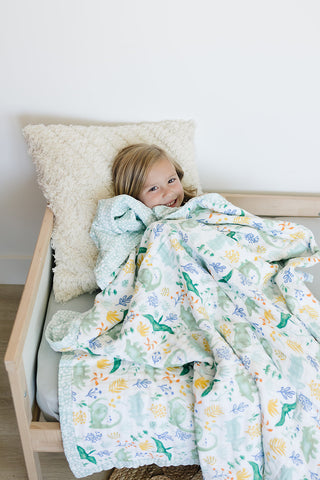 child with muslin blanket