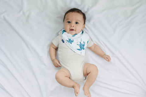 baby wearing a bebe au lait bandana bib