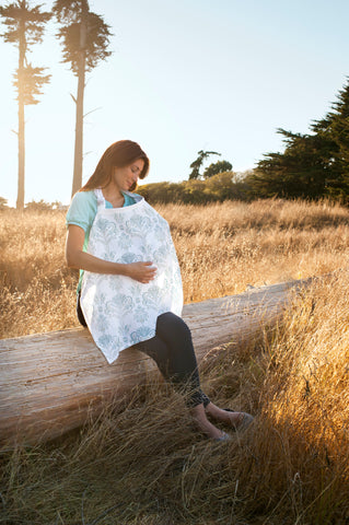 mom nursing baby under a muslin nursing cover