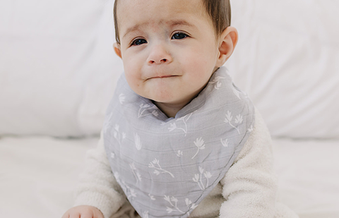 baby wearing a bebe au lait bandana bib