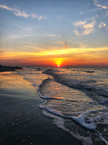 An orange sun rising over the ocean in Hilton Head Island, South Carolina