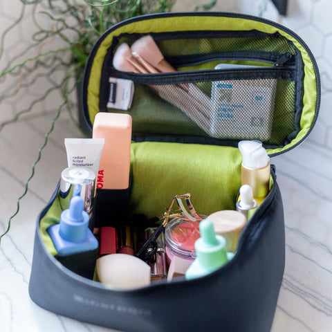 Sherpani travel accessory, the Savannah cosmetics case packed with makeup and skincare products
