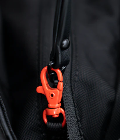 A close up view of the clip lock on the main compartment of Sherpani Anti-Theft bags