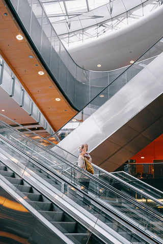 A woman alone on an airport escalator