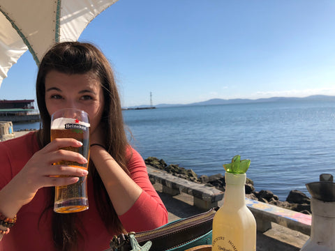 Tess sipping a beer by the Black Sea in Pomorie, Bulgaria