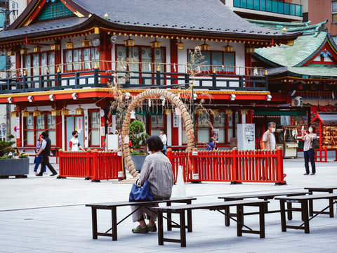 A woman sitting on a bench in Tokyo