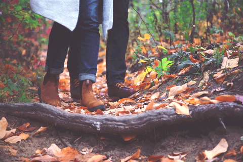 Boots walking through fall leaves