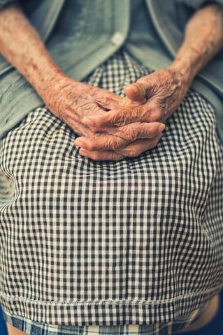 An old woman's hands folded in her lap
