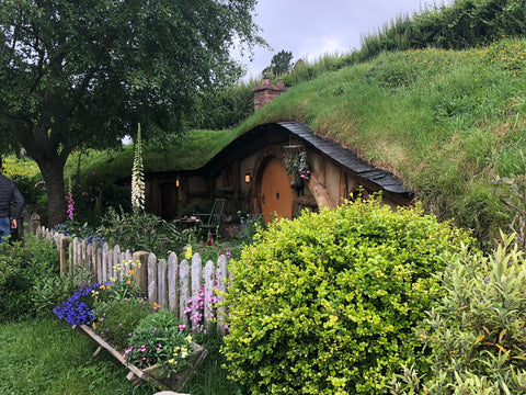 A "Hobbit Hole" house in the side of a hill at the Hobbiton movie set in New Zealand.