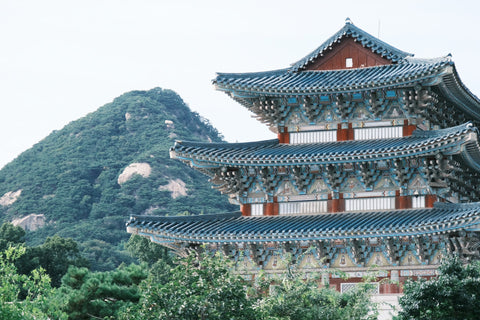 A beautiful view of Gyeongbokgung Palace with Bugaksan Mountain in the background.