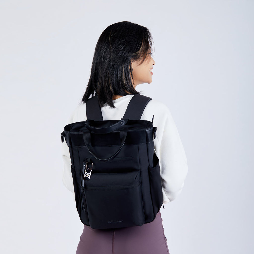 The Sherpani Soleil AT in Carbon being worn as a backpack