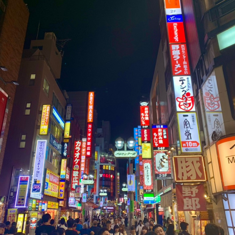 Busy city street with lights and billboards in Tokyo