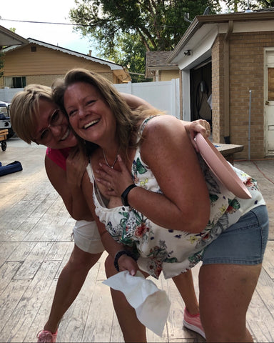 Lynn and Vicki hugging and laughing