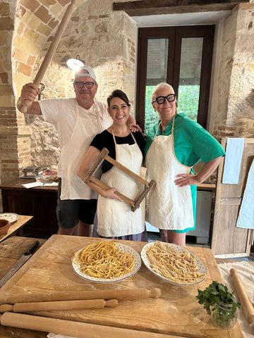 Doni and her husband in Italy taking a pasta making class