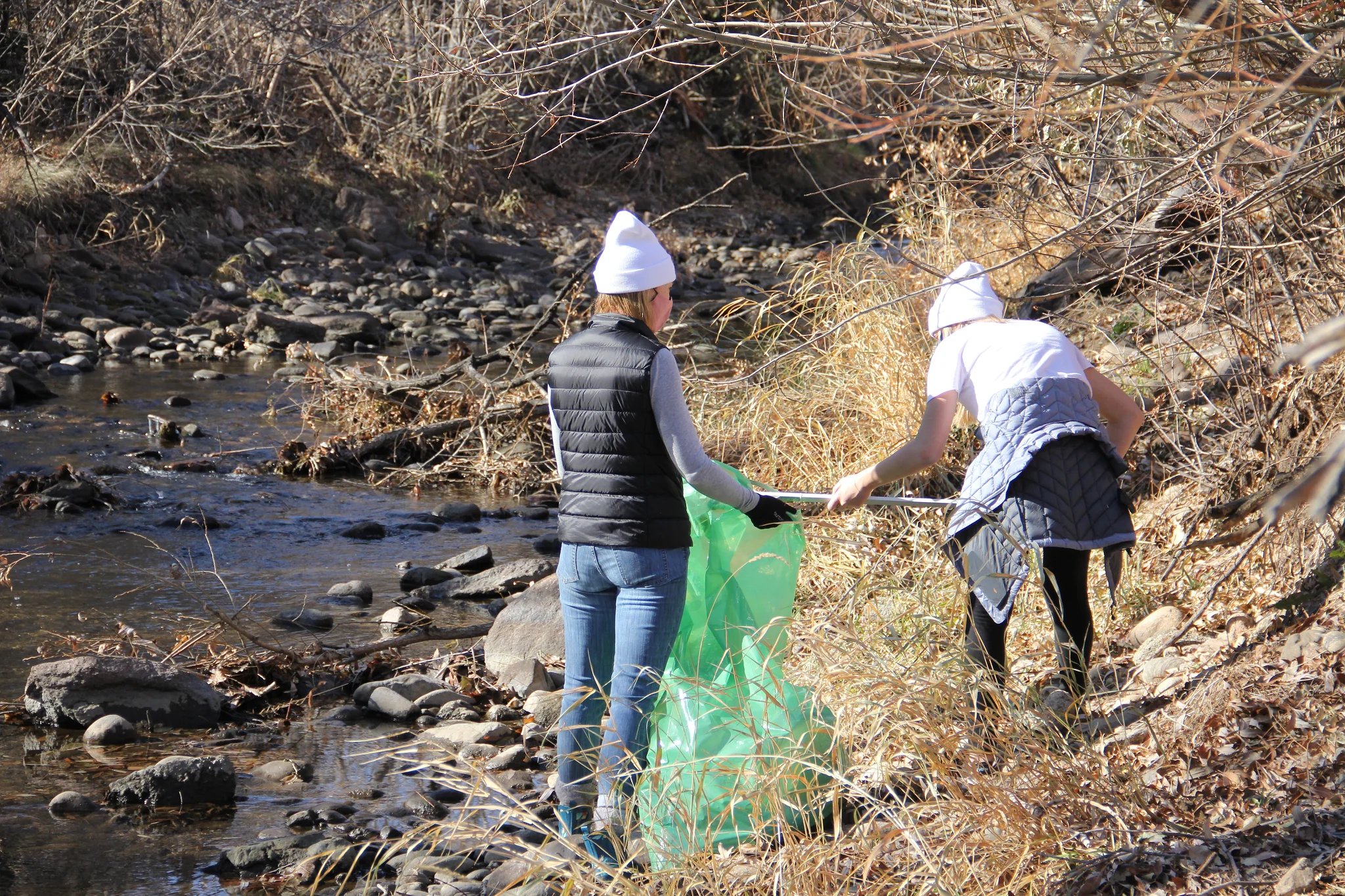 Friends picking up litter