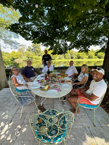 Doni and her family enjoying lunch at an outdoor table in Bordeaux, France