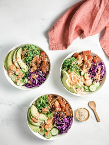 Tuna poke with fresh ground ginger bowls assembled and on a marble counter top