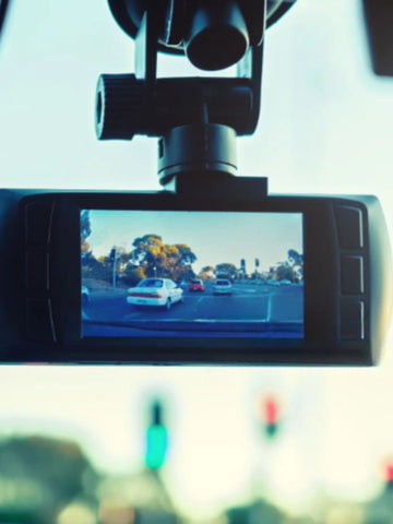 dash cam inside a car hung on windscreen
