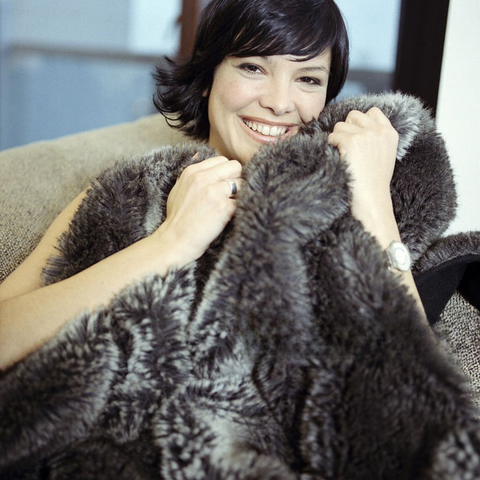 women cuddling real fur blanket