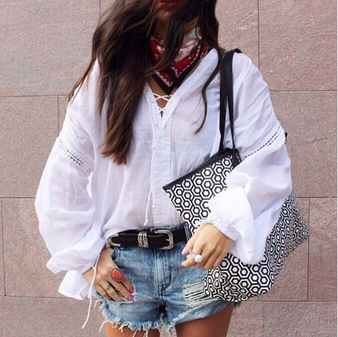 Mischa Jet Set Tote in Black being held by a woman in a white shirt and blue jean shorts