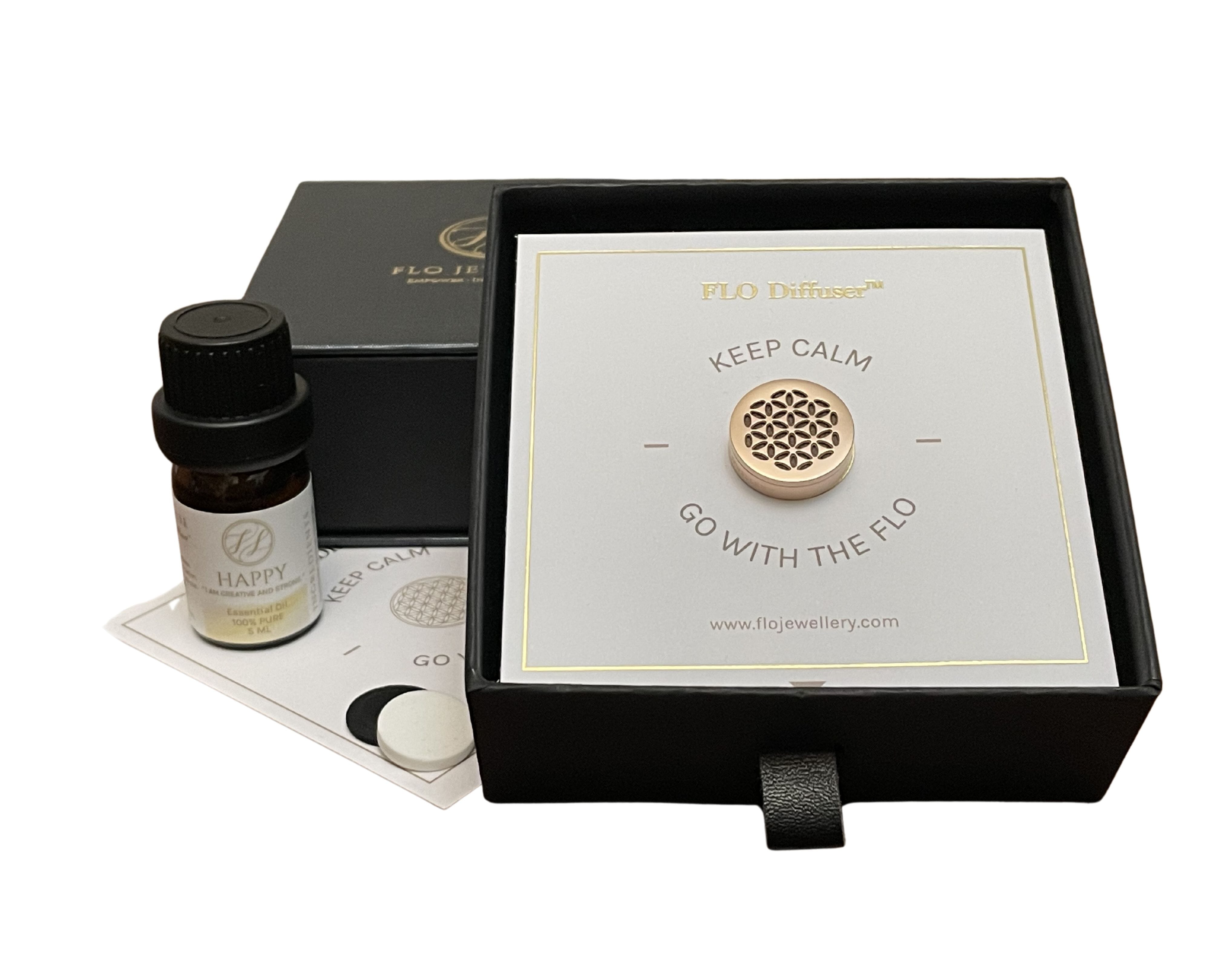 Image of the Flo Diffuser Gift set in box with small bottle of essential oils beside it