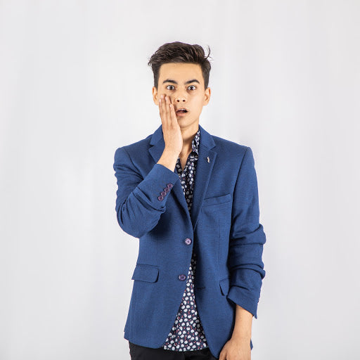Man in blue blazer and patterned shirt with hand on face | Style Standard