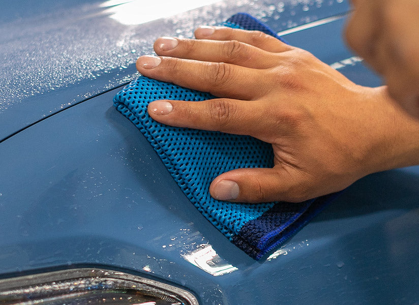 The Rag Company Ultra Clay Towel in use on the paint of a blue car