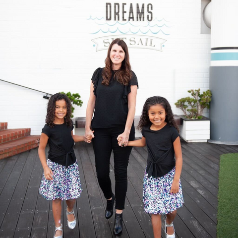 alisa mom on boardwalk with two daughters dressed in black
