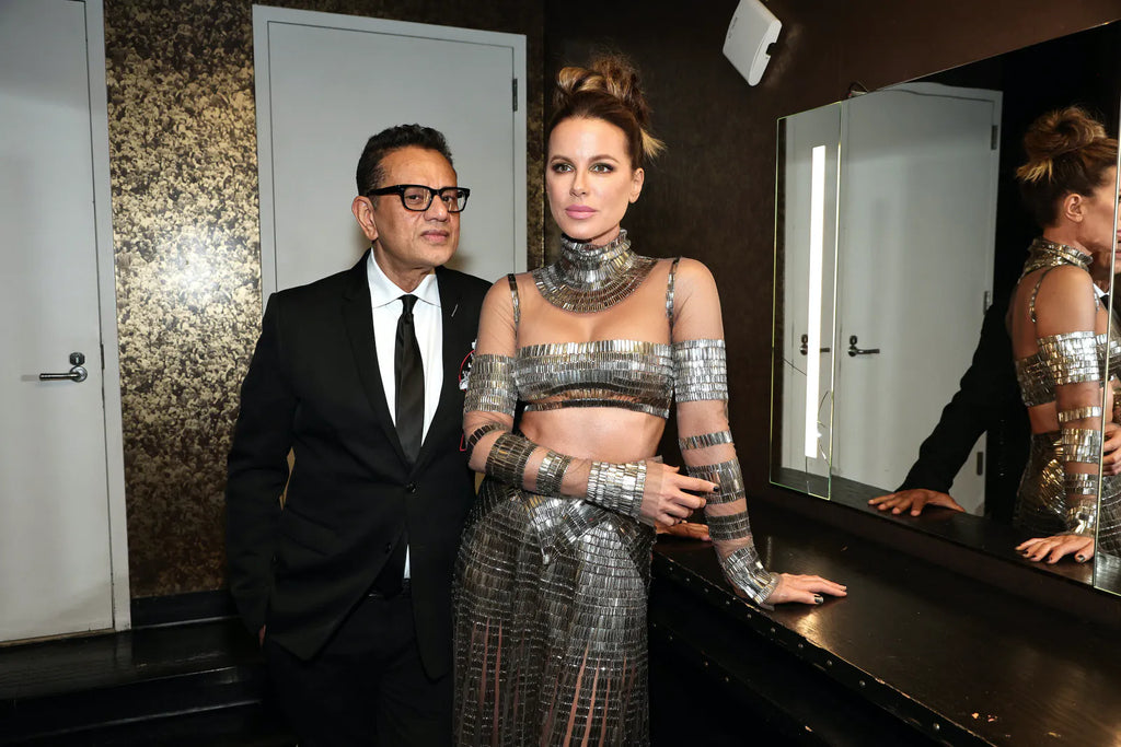 Naeem Khan stands with Kate Beckinsale wearing a metallic outfit from the Naeem Khan Fall 2023 collection.