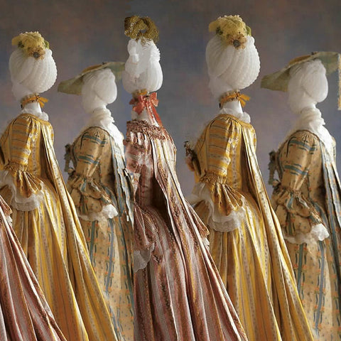 mannequins dressed in ornate, French silk dresses 