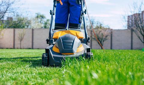 front view of a lawn mower cutting grass