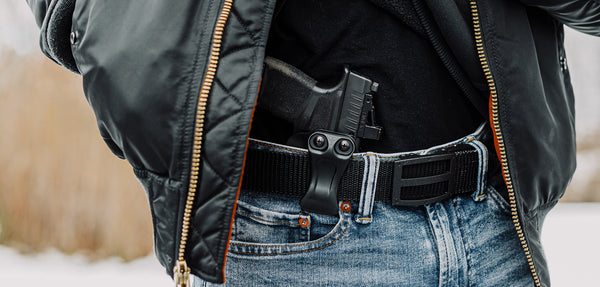 man carrying handgun using IWB holster (inside the waistband) with a concealed carry belt from Blade-Tech Holsters