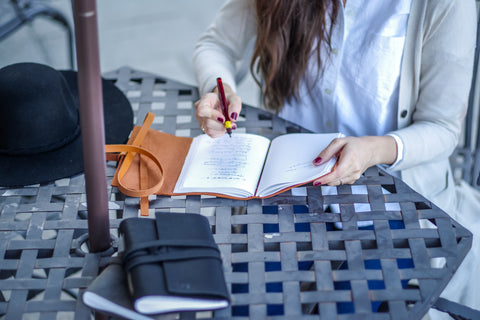 Woman writing in her personalized leather journal