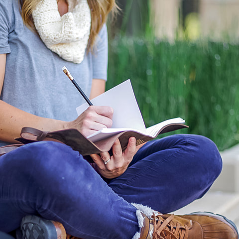 Writing in leather journal by Ox & Pine Leather Goods