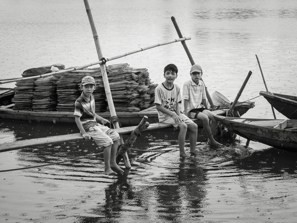 Boys on a dock in Hoi An Vietnam