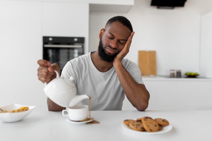 Man with Lack of Sleep spilling coffee