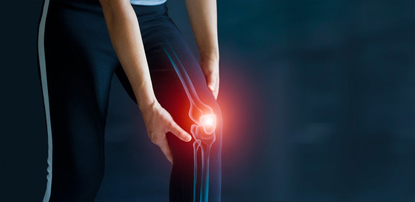 woman with joint problems holding her knee