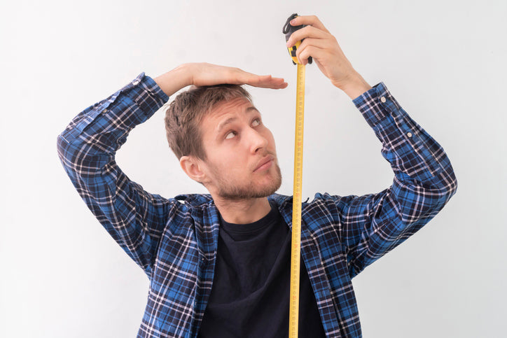 young man measuring his height