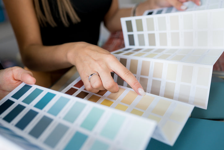 young woman choosing her favorite color from fabric swatch