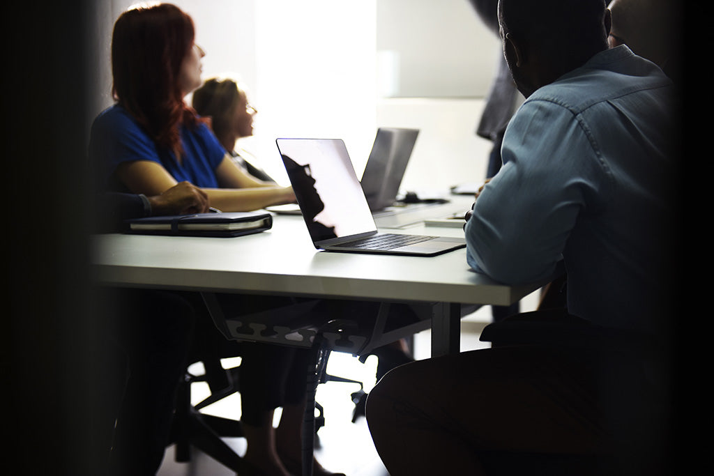 employees sitting together at a big table